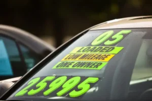 used car with stickers on the windshield